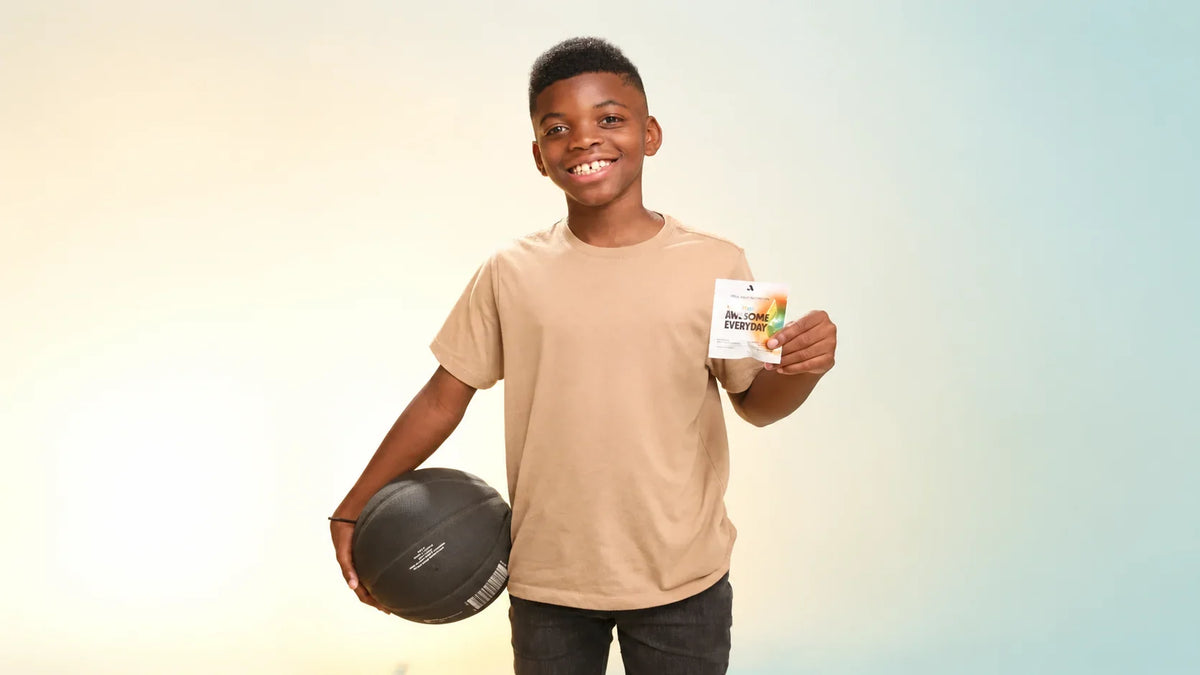  Awesome Everyday™ Kids & Teens pouch displayed with colorful gummies on a bright background.