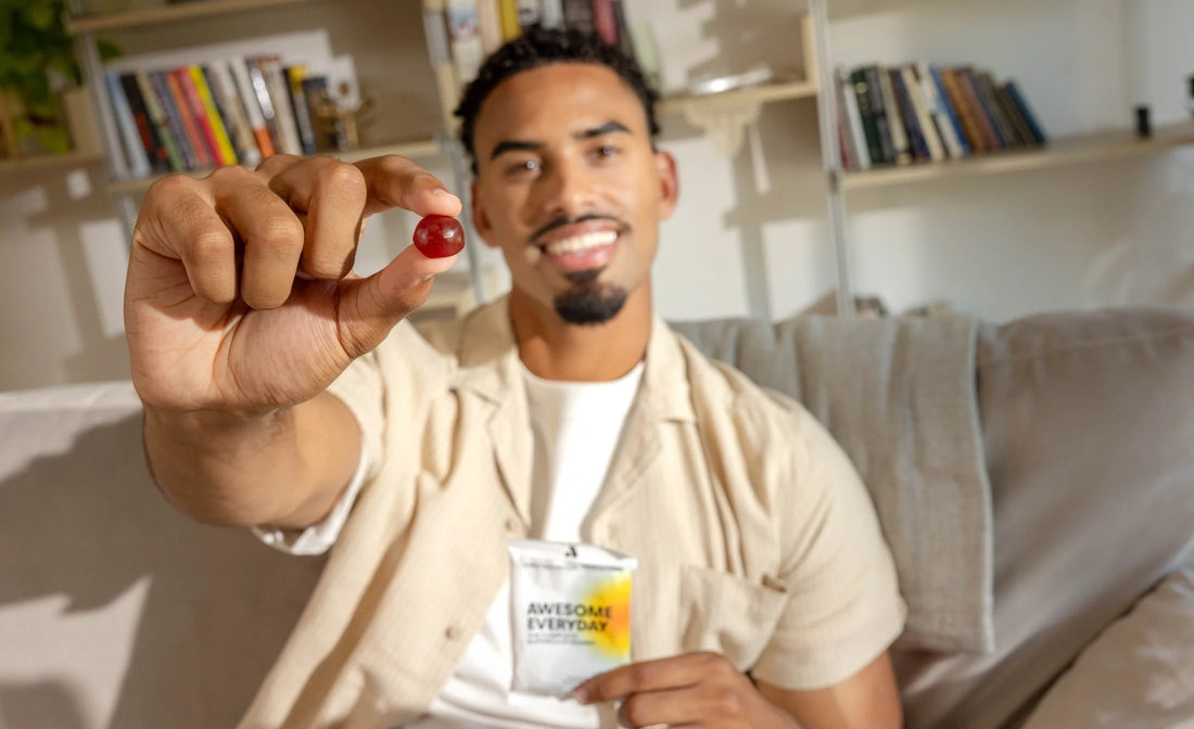  Man holding an Awesome Everyday™ gummy as part of a balanced nutrition routine.