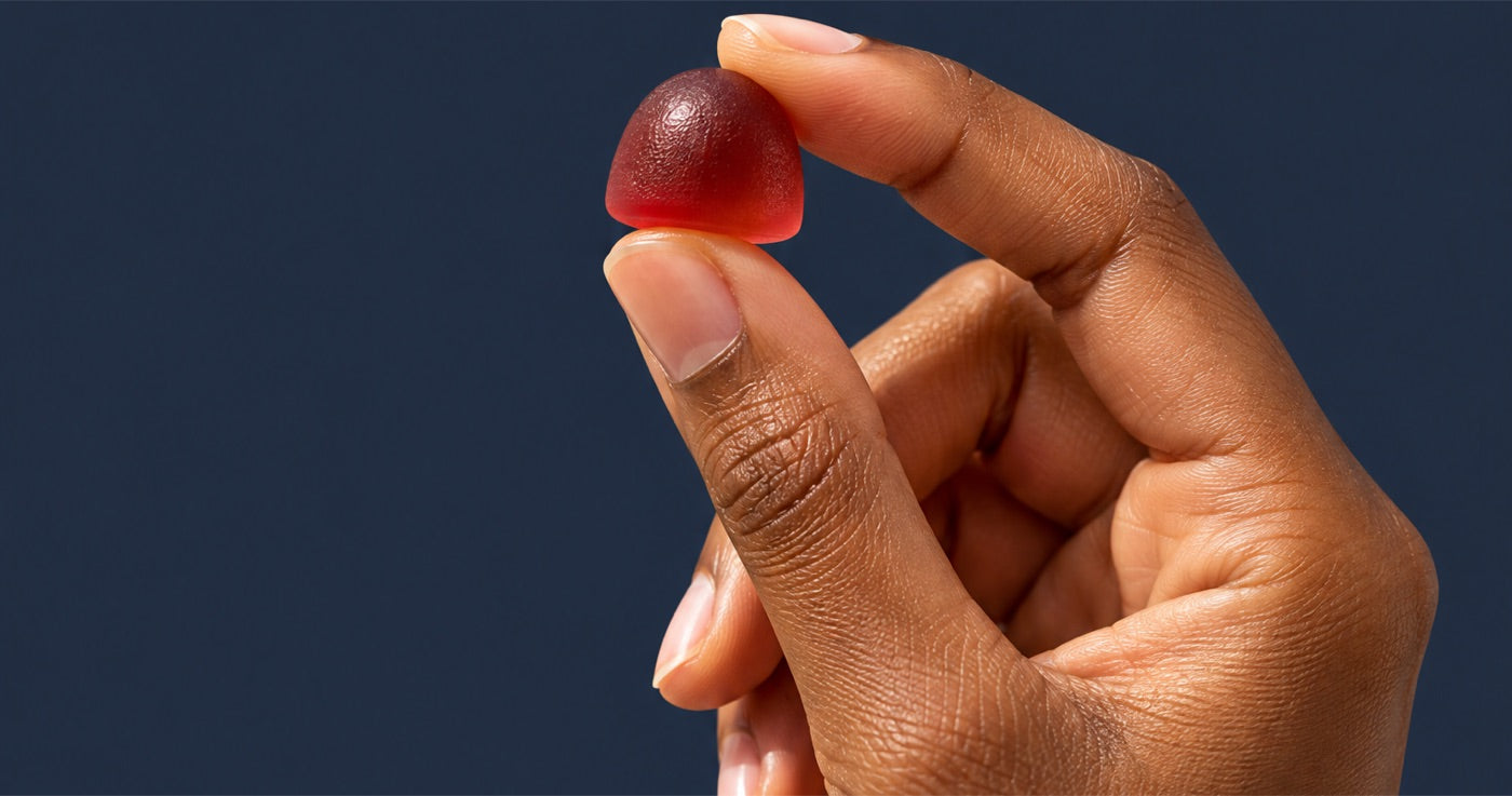 A hand holding one Awesome Everyday gummy