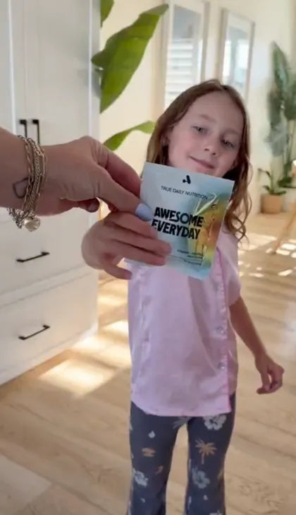 A girl holding her Awesome Everyday pack